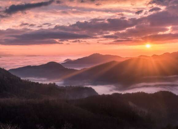 Colorful sunrise over a peaceful hill representing the Sermon on the Mount by Jesus