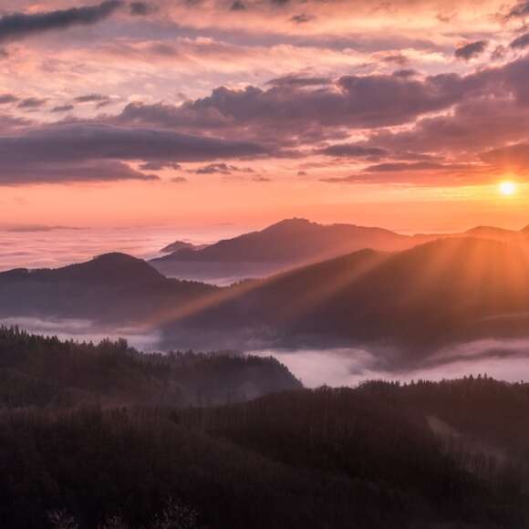 Colorful sunrise over a peaceful hill representing the Sermon on the Mount by Jesus