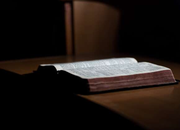 Open Bible on a desk representing the meaning of salvation and being saved