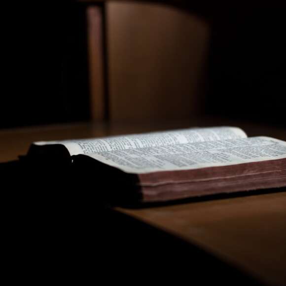Open Bible on a desk representing the meaning of salvation and being saved